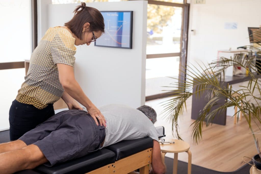 Senior man having chiropractic adjustment same-day chiropractor Fairfax VA