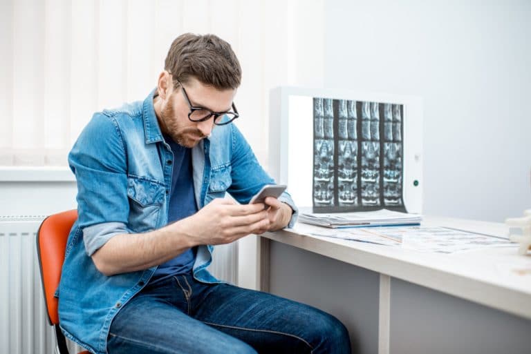 Man sitting hunched down in the office of therapist